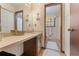 Bathroom with extended vanity and connecting toilet room with floral wallpaper at 2062 Cezar Nw Dr, Kennesaw, GA 30152