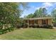 Charming home showcasing red shutters and a well-manicured lawn at 2062 Cezar Nw Dr, Kennesaw, GA 30152