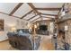 Living room with stone fireplace and exposed beams at 2062 Cezar Nw Dr, Kennesaw, GA 30152