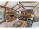 Living room with stone fireplace, wood beams, and built-in bookcase at 2062 Cezar Nw Dr, Kennesaw, GA 30152