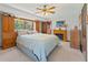 Cozy main bedroom with built-in cabinets, fireplace, and ceiling fan at 2062 Cezar Nw Dr, Kennesaw, GA 30152