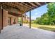 Covered back patio with brickwork and view of the spacious backyard at 2400 Gants Hill Pl, Cumming, GA 30041