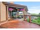 Spacious covered porch with comfortable seating and a view of the lush backyard at 2400 Gants Hill Pl, Cumming, GA 30041