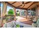 Covered back porch with wood flooring, ceiling fan and outdoor seating area at 2400 Gants Hill Pl, Cumming, GA 30041