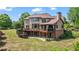 Spacious backyard featuring a multi-level deck, patio, and lush greenery for outdoor enjoyment at 2400 Gants Hill Pl, Cumming, GA 30041