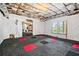 Unfinished basement with colorful carpet tiles, exposed ceiling, and ample space at 2400 Gants Hill Pl, Cumming, GA 30041