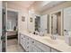 Bathroom with double vanity, white cabinets and tiled floors at 2400 Gants Hill Pl, Cumming, GA 30041