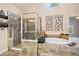 Bright bathroom featuring a glass shower, soaking tub, and decorative wall art at 2400 Gants Hill Pl, Cumming, GA 30041