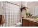 Neutral bathroom featuring a shower-tub combo, tile, a wood vanity and a granite counter at 2400 Gants Hill Pl, Cumming, GA 30041