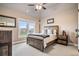 Bedroom with hardwood bed frame, bedside table and large window at 2400 Gants Hill Pl, Cumming, GA 30041