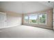 This spacious bedroom has carpet flooring and great natural light from the oversized windows at 2400 Gants Hill Pl, Cumming, GA 30041