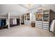 Spacious walk-in closet with custom built-in shelving and ample hanging space at 2400 Gants Hill Pl, Cumming, GA 30041
