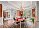 Open dining room with natural light and beautiful chandelier at 2400 Gants Hill Pl, Cumming, GA 30041