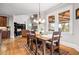 Open-concept dining area showcases hardwood floors, abundant natural light, and a stylish chandelier at 2400 Gants Hill Pl, Cumming, GA 30041