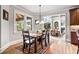 Elegant dining room with hardwood floors, chandelier, and views to the living room and porch at 2400 Gants Hill Pl, Cumming, GA 30041