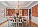 Formal dining room with tray ceiling, chandelier, and access to adjacent rooms at 2400 Gants Hill Pl, Cumming, GA 30041