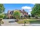 Brick home with a spacious driveway leading to a two-car garage and well-kept landscaping at 2400 Gants Hill Pl, Cumming, GA 30041