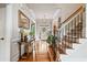 Inviting foyer with hardwood floors, staircase, and view of the front door at 2400 Gants Hill Pl, Cumming, GA 30041