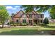 Beautiful brick home featuring manicured landscaping and stone accents on the facade at 2400 Gants Hill Pl, Cumming, GA 30041