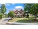 Charming brick home with lush lawn, mature trees, and well-maintained landscaping at 2400 Gants Hill Pl, Cumming, GA 30041