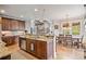 Open kitchen with custom cabinetry, stainless steel appliances, and a view of the dining area and living room at 2400 Gants Hill Pl, Cumming, GA 30041
