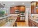 Gourmet kitchen with stainless steel appliances, granite countertops, and custom cabinetry at 2400 Gants Hill Pl, Cumming, GA 30041