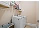 Laundry room with modern washer and dryer and storage shelves at 2400 Gants Hill Pl, Cumming, GA 30041