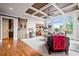 Open-concept living room with coffered ceilings, hardwood floors, and large windows at 2400 Gants Hill Pl, Cumming, GA 30041