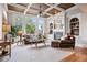 Bright living room boasting coffered ceilings, large windows, built-in shelves, and a fireplace at 2400 Gants Hill Pl, Cumming, GA 30041