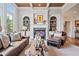 Elegant living room with a marble fireplace, built-in shelving, and stylish leather furniture at 2400 Gants Hill Pl, Cumming, GA 30041