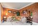Warm living room with comfortable seating, accent wall, and natural light at 2400 Gants Hill Pl, Cumming, GA 30041