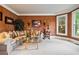 Comfortable living room with cozy seating, large windows, and neutral carpeting at 2400 Gants Hill Pl, Cumming, GA 30041