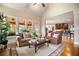 Sunlit living room with hardwood floors, neutral colors, and an open floor plan to the kitchen at 2400 Gants Hill Pl, Cumming, GA 30041