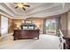 This is a spacious main bedroom with vaulted ceilings, large windows, and carpet flooring at 2400 Gants Hill Pl, Cumming, GA 30041
