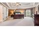 This beautiful main bedroom is styled with an oversized bed, vaulted ceiling, and many windows at 2400 Gants Hill Pl, Cumming, GA 30041