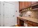 Mudroom with custom cabinets, granite countertops, and tiled backsplash at 2400 Gants Hill Pl, Cumming, GA 30041