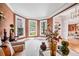 Bright sitting room featuring large windows, neutral tones, and an open doorway to the dining area at 2400 Gants Hill Pl, Cumming, GA 30041