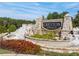 Community entrance sign with stone details and manicured landscaping and colorful plants at 3051 Greyton Dr, Buford, GA 30519