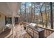 Relaxing back porch with a grill and swing overlooking a serene wooded backyard with lake view at 4211 Burnt Hickory Nw Rd, Marietta, GA 30064