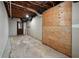 Unfinished basement featuring an exposed ceiling, wood walls and concrete floor, and an exit door at 4211 Burnt Hickory Nw Rd, Marietta, GA 30064