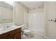 Bathroom with a wood vanity, white toilet and tub, a decorative border, and tile flooring at 4211 Burnt Hickory Nw Rd, Marietta, GA 30064