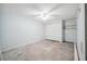 Unfinished bedroom with a ceiling fan, closet, shelving, and concrete floor ready to be renovated at 4211 Burnt Hickory Nw Rd, Marietta, GA 30064