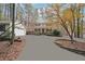 Charming home with a well-manicured front yard and a long driveway leading to the garage at 4211 Burnt Hickory Nw Rd, Marietta, GA 30064