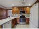 Well-equipped kitchen features wooden cabinetry, stainless steel appliances, and ample countertop space at 4211 Burnt Hickory Nw Rd, Marietta, GA 30064