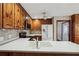 Well-lit kitchen featuring wood cabinets, modern appliances, and a white countertop with a sink and tile backsplash at 4211 Burnt Hickory Nw Rd, Marietta, GA 30064