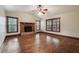 Spacious living room with hardwood floors, a brick fireplace, large windows with wood trim and a ceiling fan at 4211 Burnt Hickory Nw Rd, Marietta, GA 30064