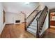 Inviting living room with hardwood floors, a cozy fireplace, and a classic staircase leading to the upper level at 4211 Burnt Hickory Nw Rd, Marietta, GA 30064