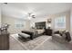 Spacious main bedroom featuring a decorative ceiling fan, elegant furnishings, and natural light from multiple windows at 4211 Burnt Hickory Nw Rd, Marietta, GA 30064