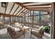 Bright sun room featuring comfortable seating, perfect for relaxing or entertaining while enjoying nature views at 4211 Burnt Hickory Nw Rd, Marietta, GA 30064