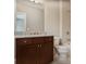 Bathroom with dark wood cabinets, granite countertop, with neutral colored walls and flooring at 4884 Kentwood Dr, Marietta, GA 30068